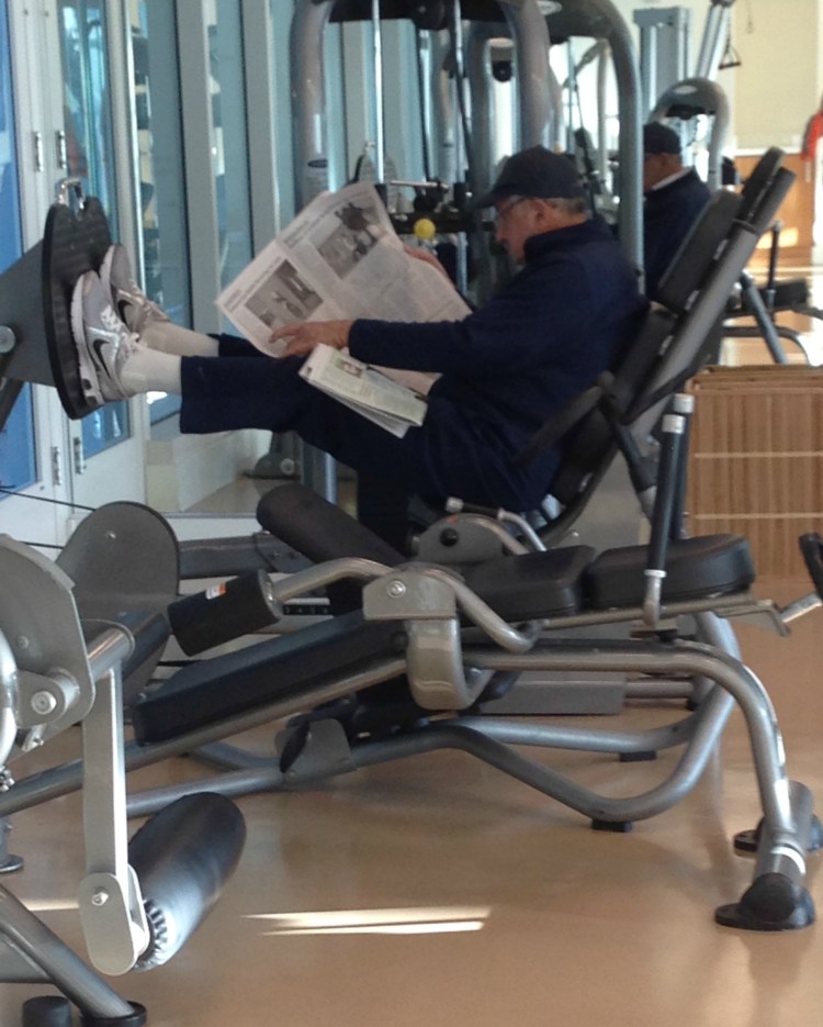 man reading while on leg press machine, simply social blog